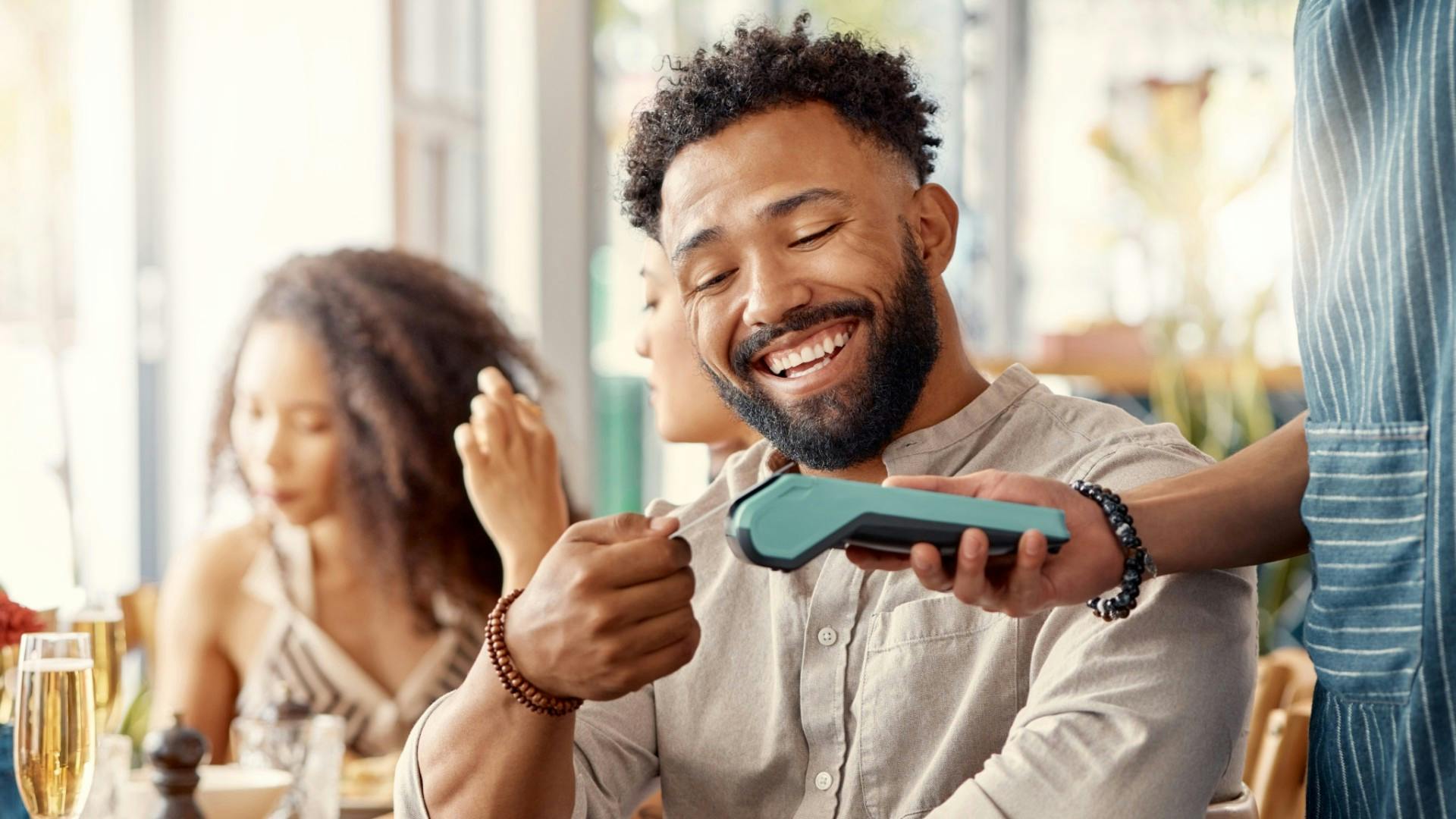 Man using a card to pay the bill.