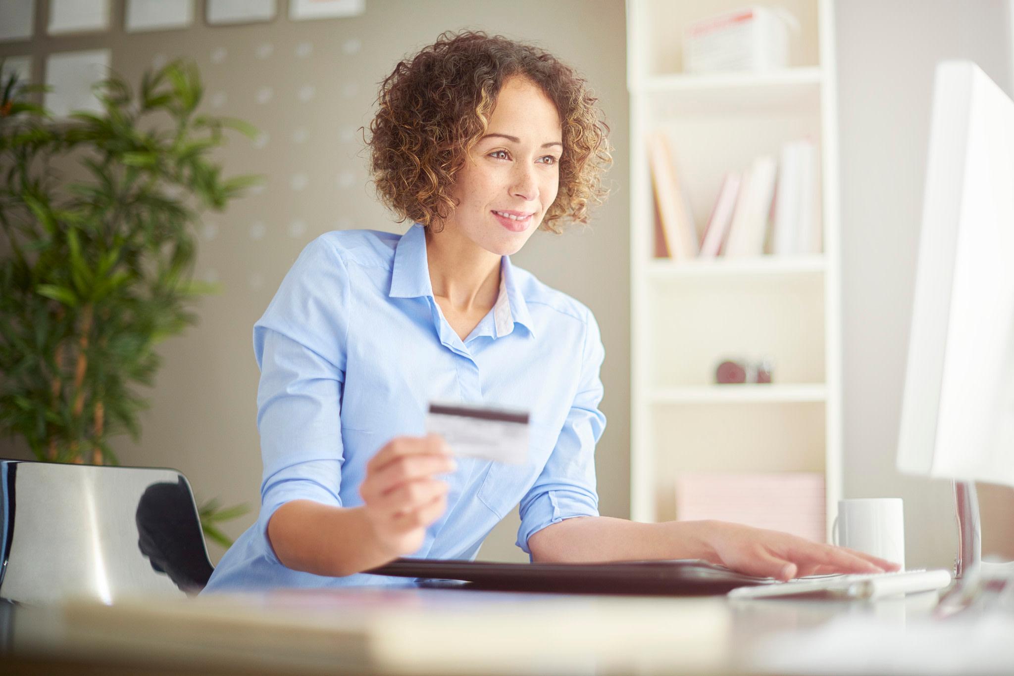 A businesswoman with a card.