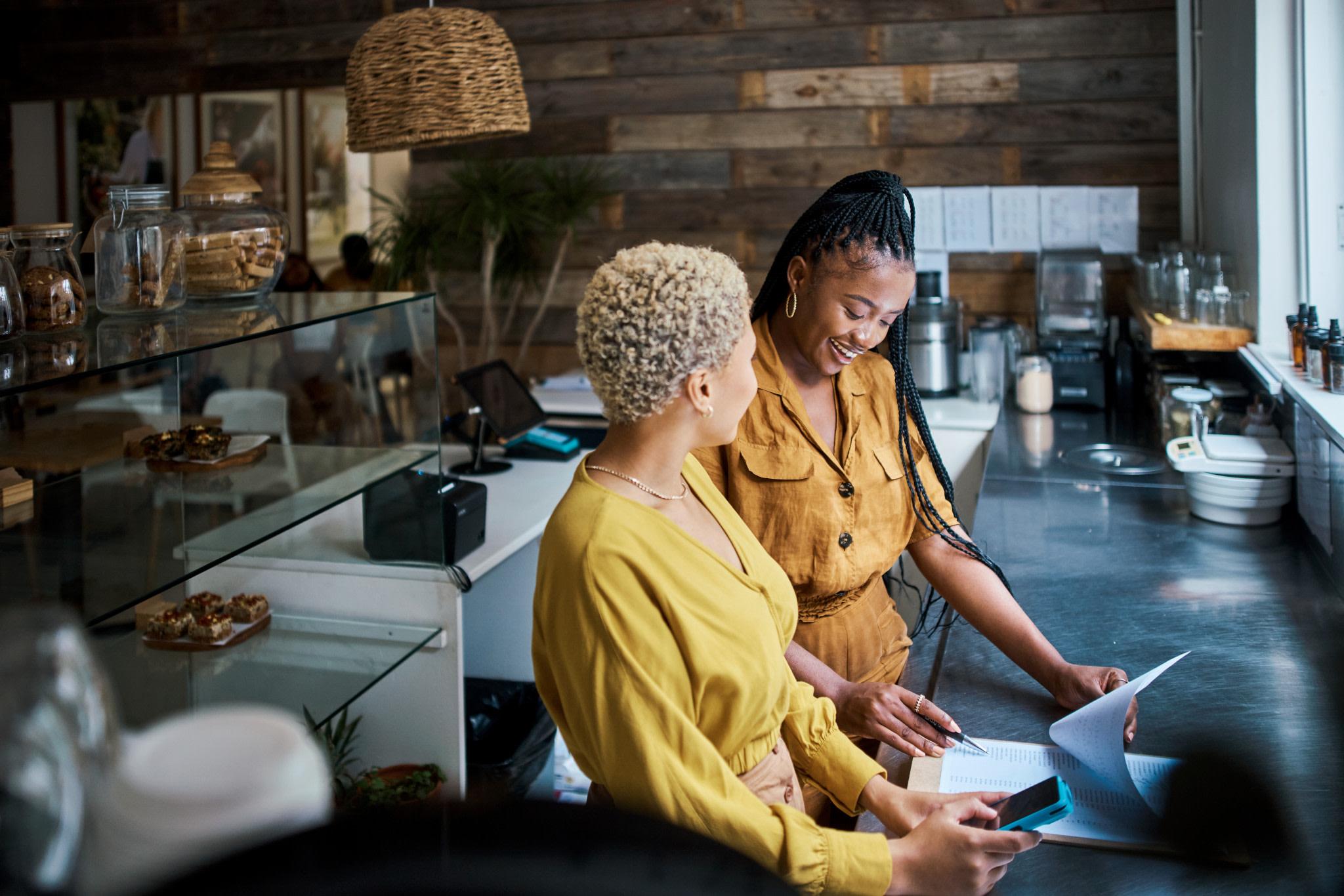 Businesswomen running a bakery and banking online.