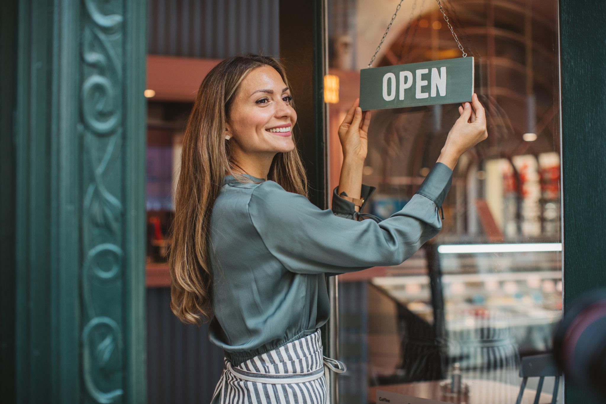 Business woman opening cafe.